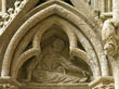 Panel 01:06 - Male figure with hood (cleric?) gesturing towards the north transept door